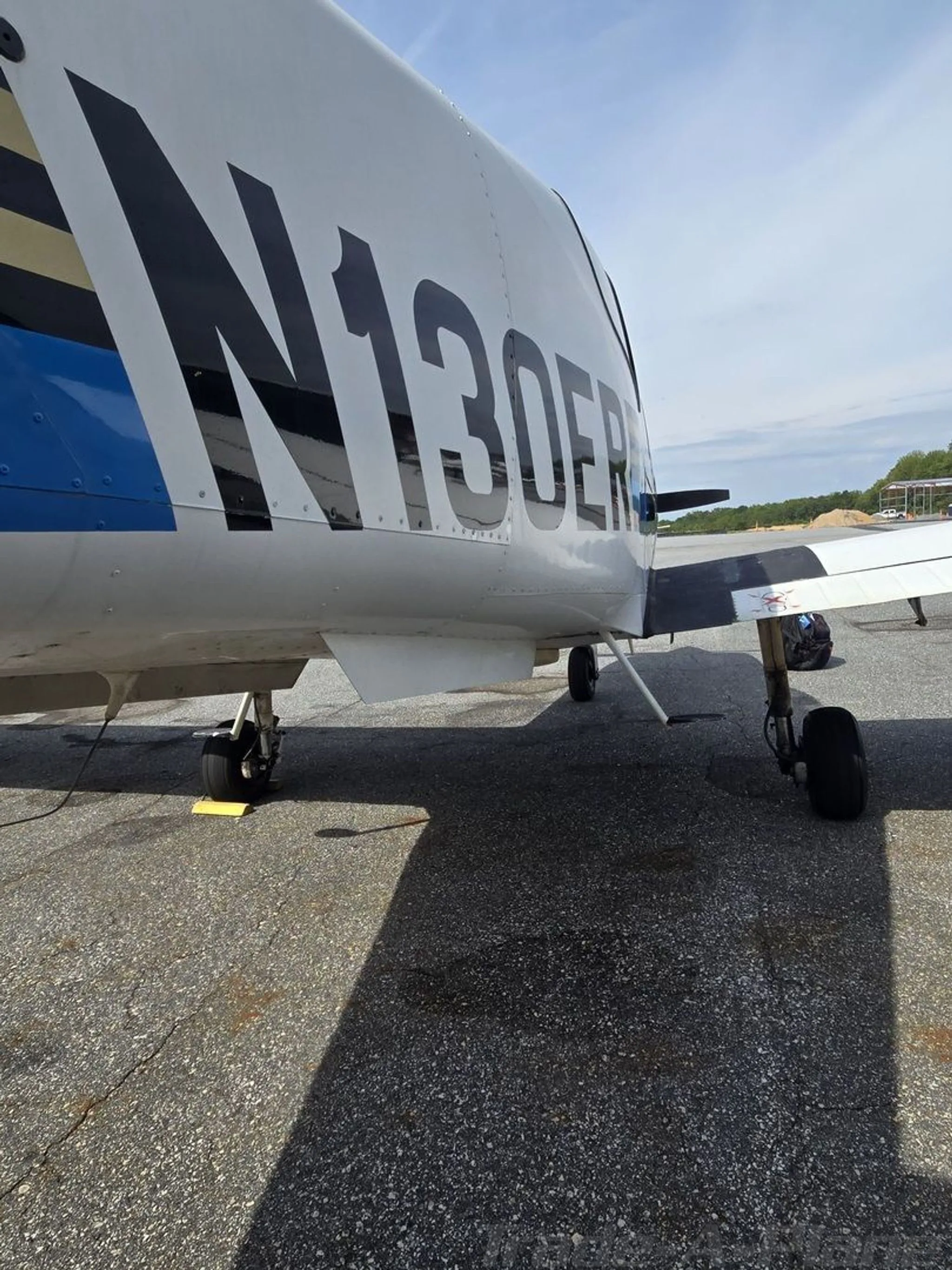 A close-up view of the tail section of the N130ER aircraft, showing the tail number and landing gear.