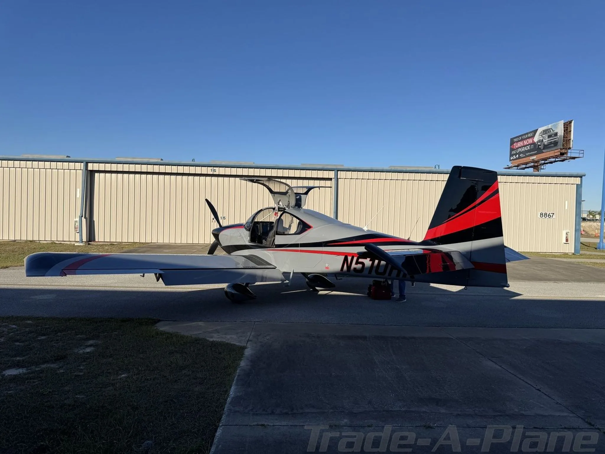 Back view of the aircraft with hangars in the background.