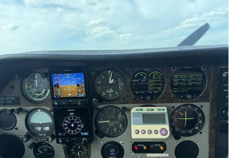 A close-up view of the aircraft's instrument panel, featuring analog gauges and modern digital displays.