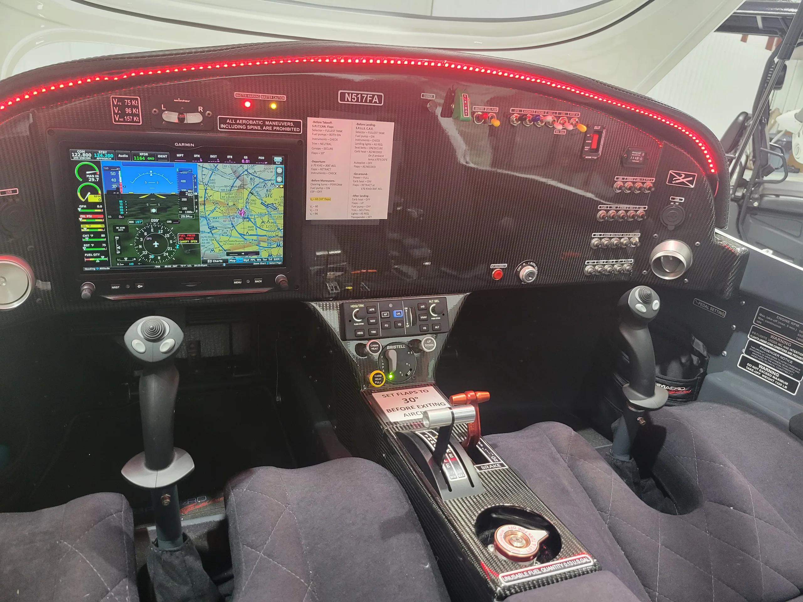 The cockpit of a light sport aircraft, featuring a Garmin G3X Touch display, dual side sticks, and a carbon fiber panel.