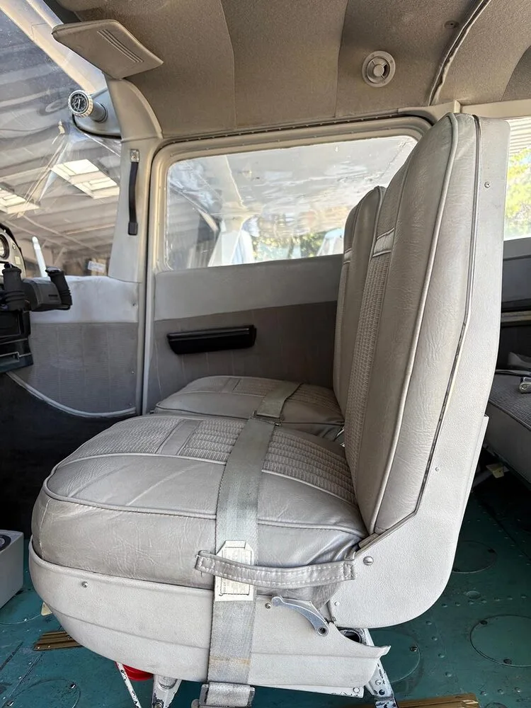 The gray fabric and vinyl front passenger seat of a Cessna aircraft, viewed from the side.