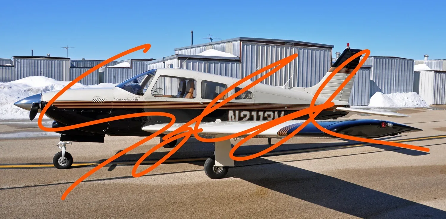 A white and black Piper Turbo Arrow III aircraft with brown stripes parked on an airfield ramp.