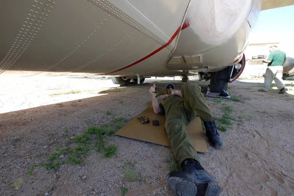 A technician working under the C-130 Hercules.