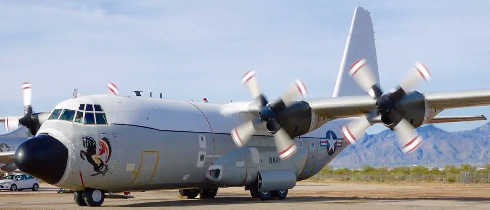 A C-130 Hercules in a side view with propellers.