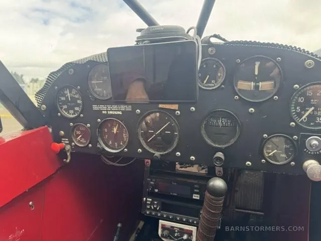 The cockpit instrument panel of the Super Cub, featuring analog gauges and a mounted tablet.