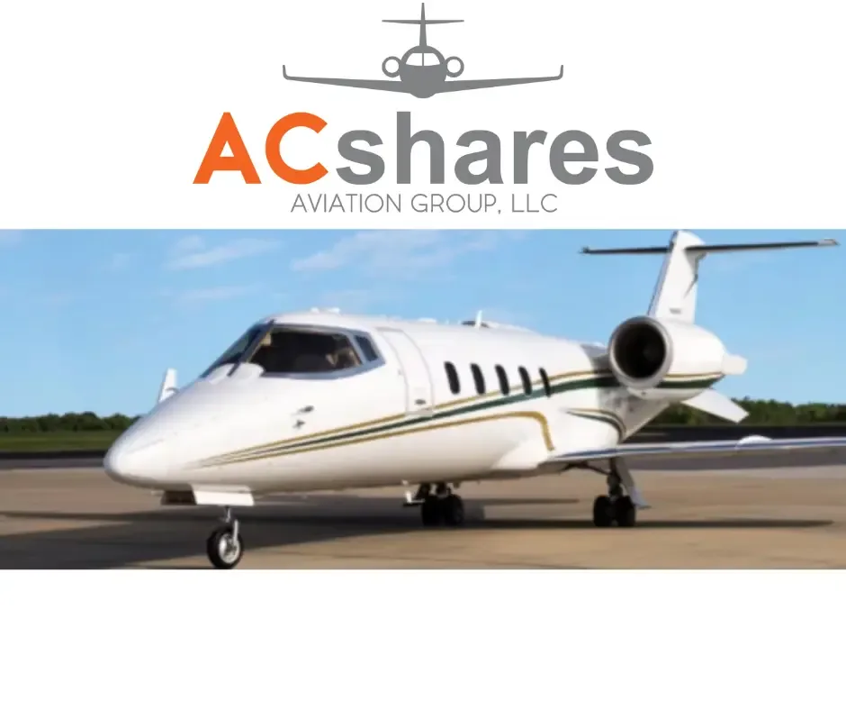 A white business jet with green and gold stripes is parked on a tarmac, beneath the ACshares Aviation Group logo.