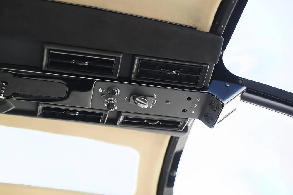 An overhead view of air vents and controls inside a helicopter cabin.