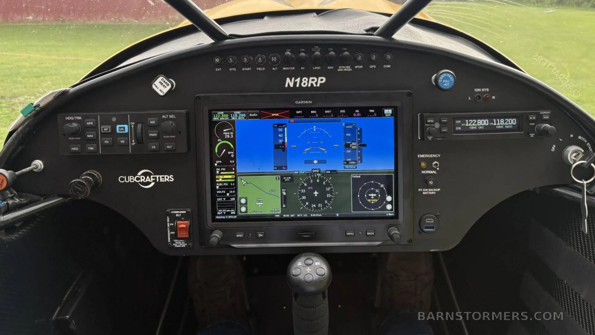The cockpit of a CubCrafters Carbon Cub, featuring a large Garmin G3X Touch display and other avionics.
