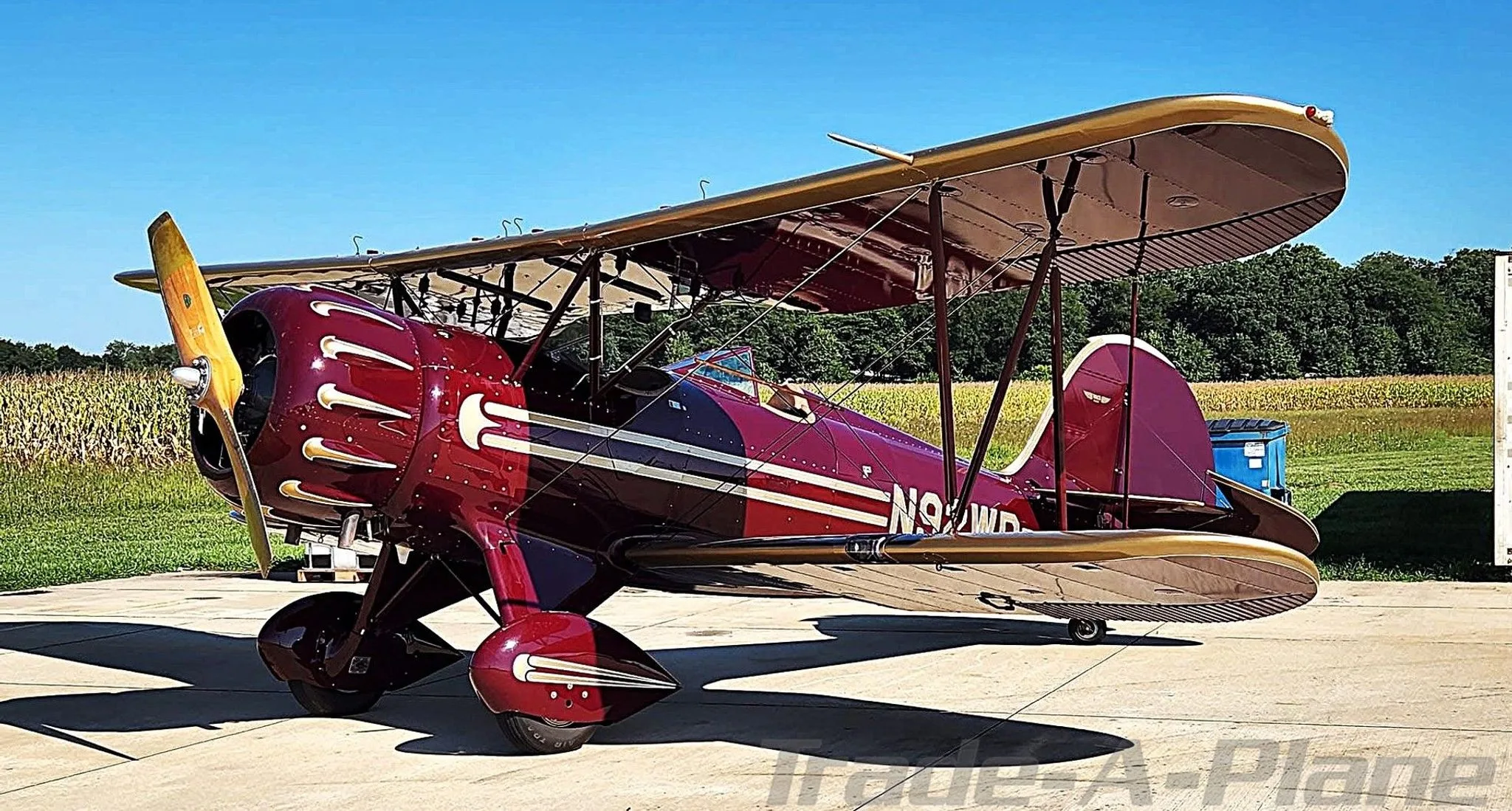 A WACO YMF-5C parked on the tarmac.