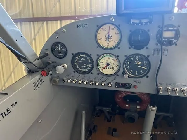 The gray instrument panel of a small aircraft, showing various gauges and switches, with tail number N226T.