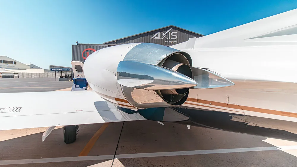 A close-up view of the polished engine nacelle and tail section of a white Cessna Citation jet.