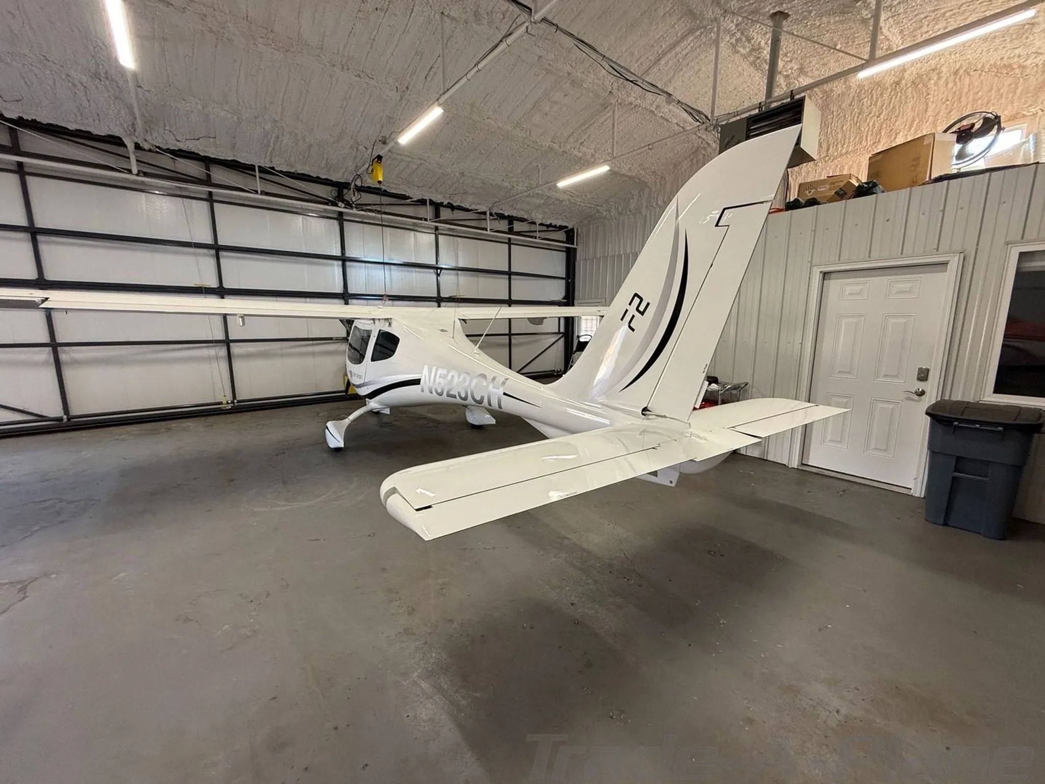 A view of the aircraft from the back, highlighting its wings.