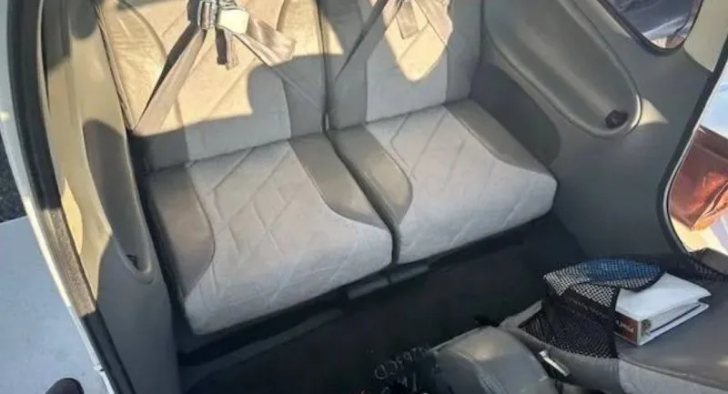 The light gray and white rear cabin seats of a Cirrus SR20 aircraft.