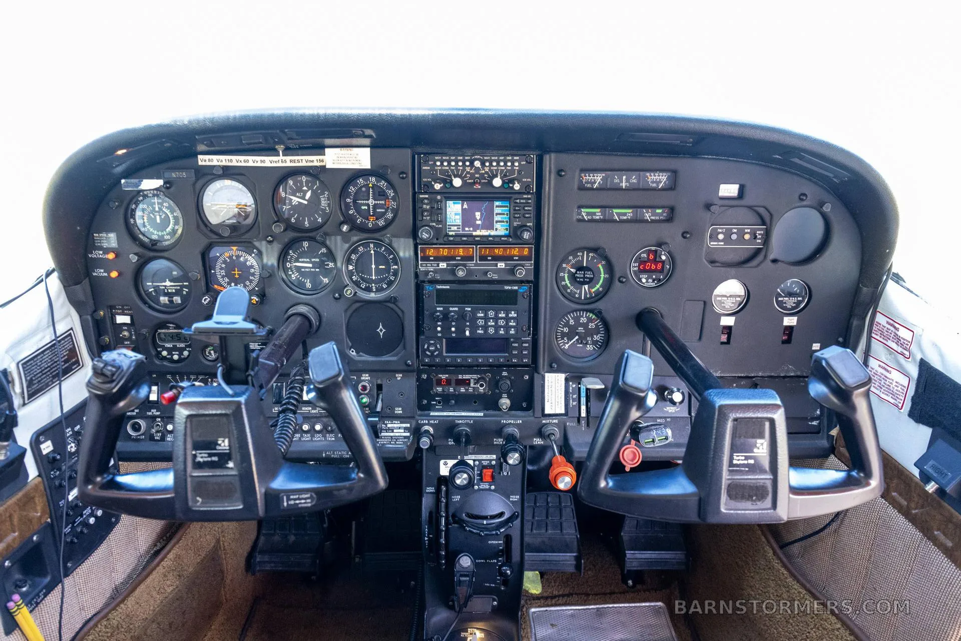 The cockpit of a Cessna 182 Skylane 50 features a detailed instrument panel with analog gauges, modern avionics, and dual control yokes.