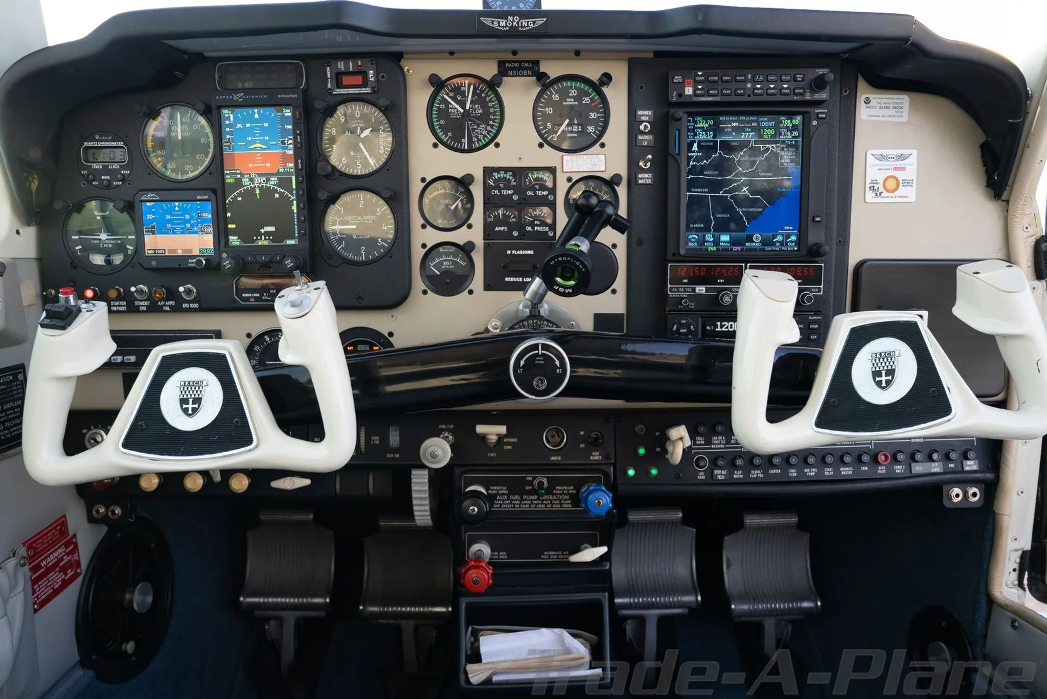 The cockpit instrument panel of the Beechcraft Bonanza, featuring both analog gauges and modern digital displays.