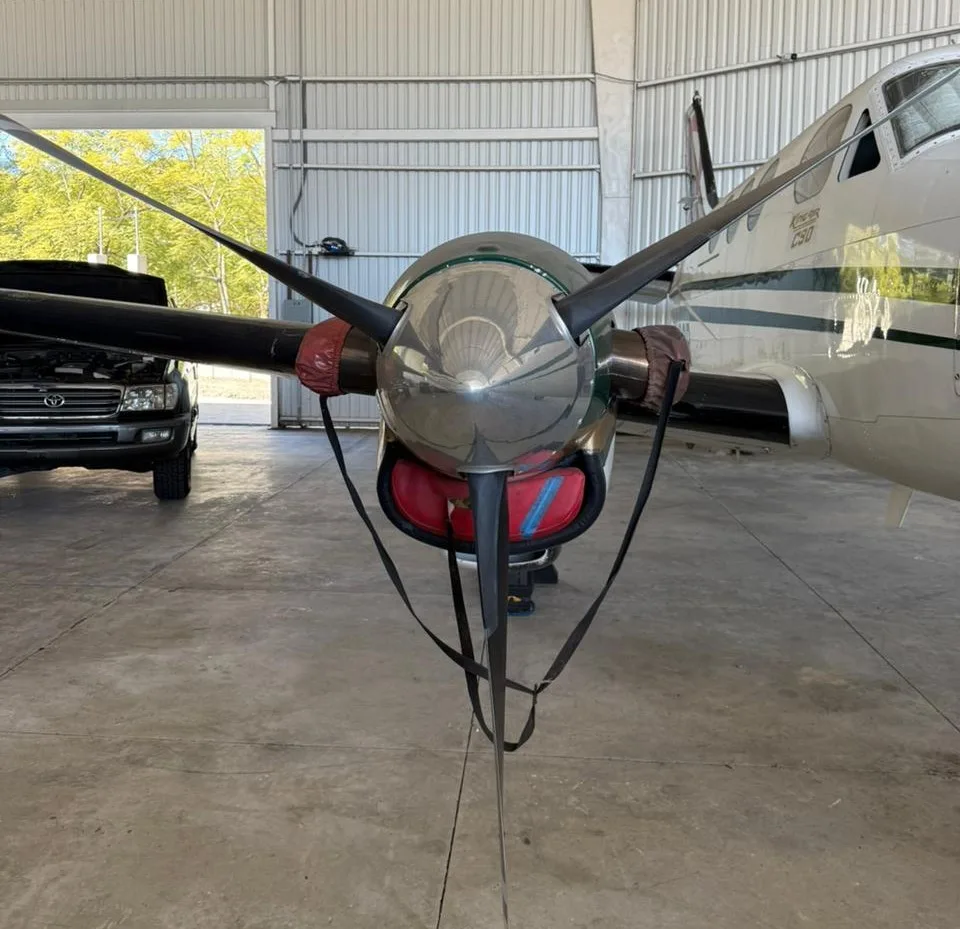 Front view of the right engine and propeller of a King Air C90 aircraft, with engine inlet covers.