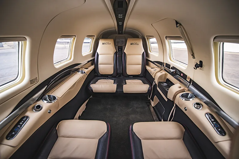 Interior view of the M600 SLS aircraft cabin with leather seats.