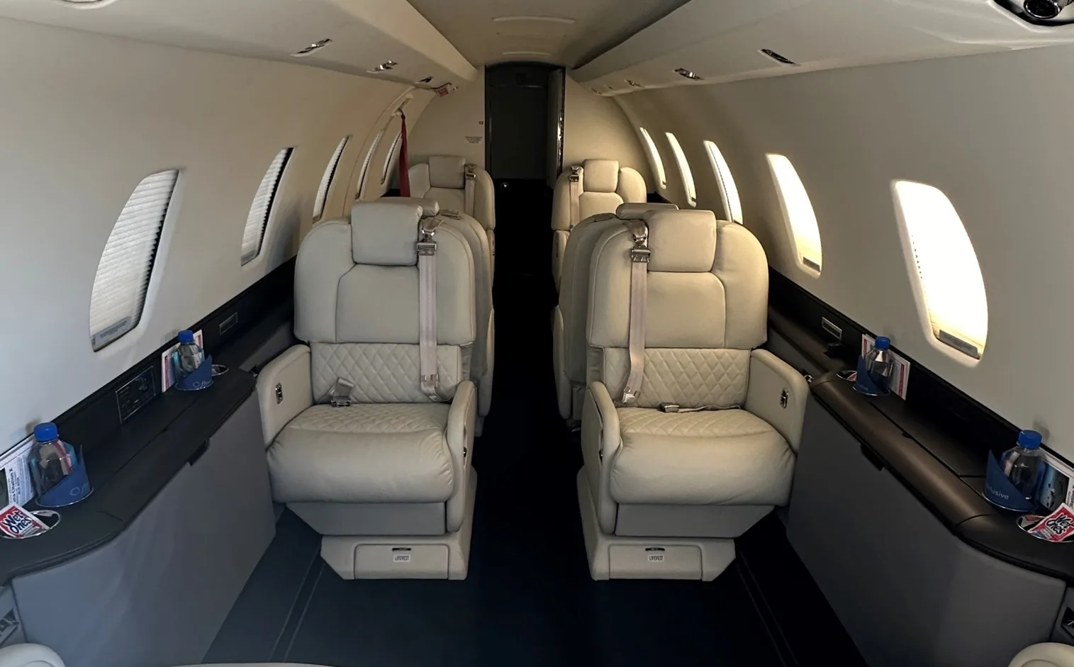 View of the aircraft's interior with white leather seats.