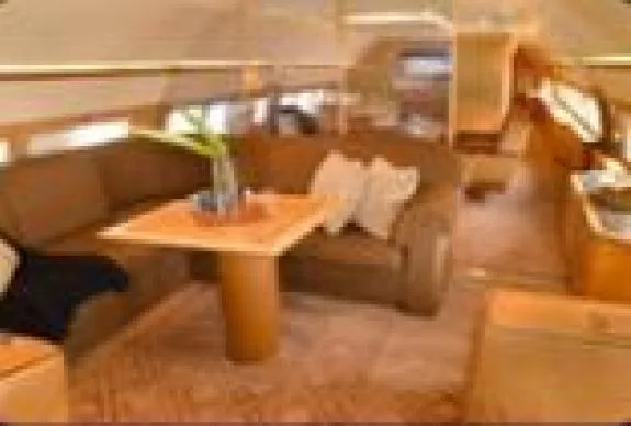 The aircraft's interior includes a sofa and table.