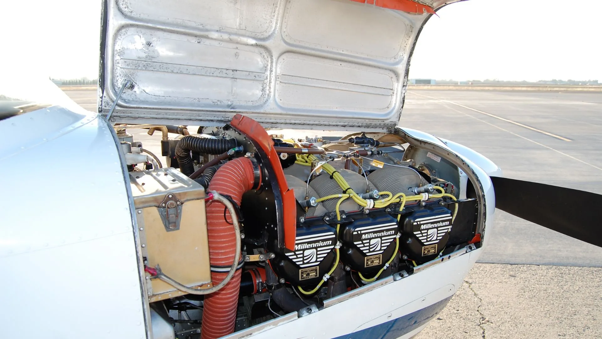Close-up of the aircraft's engine with the cowling open.