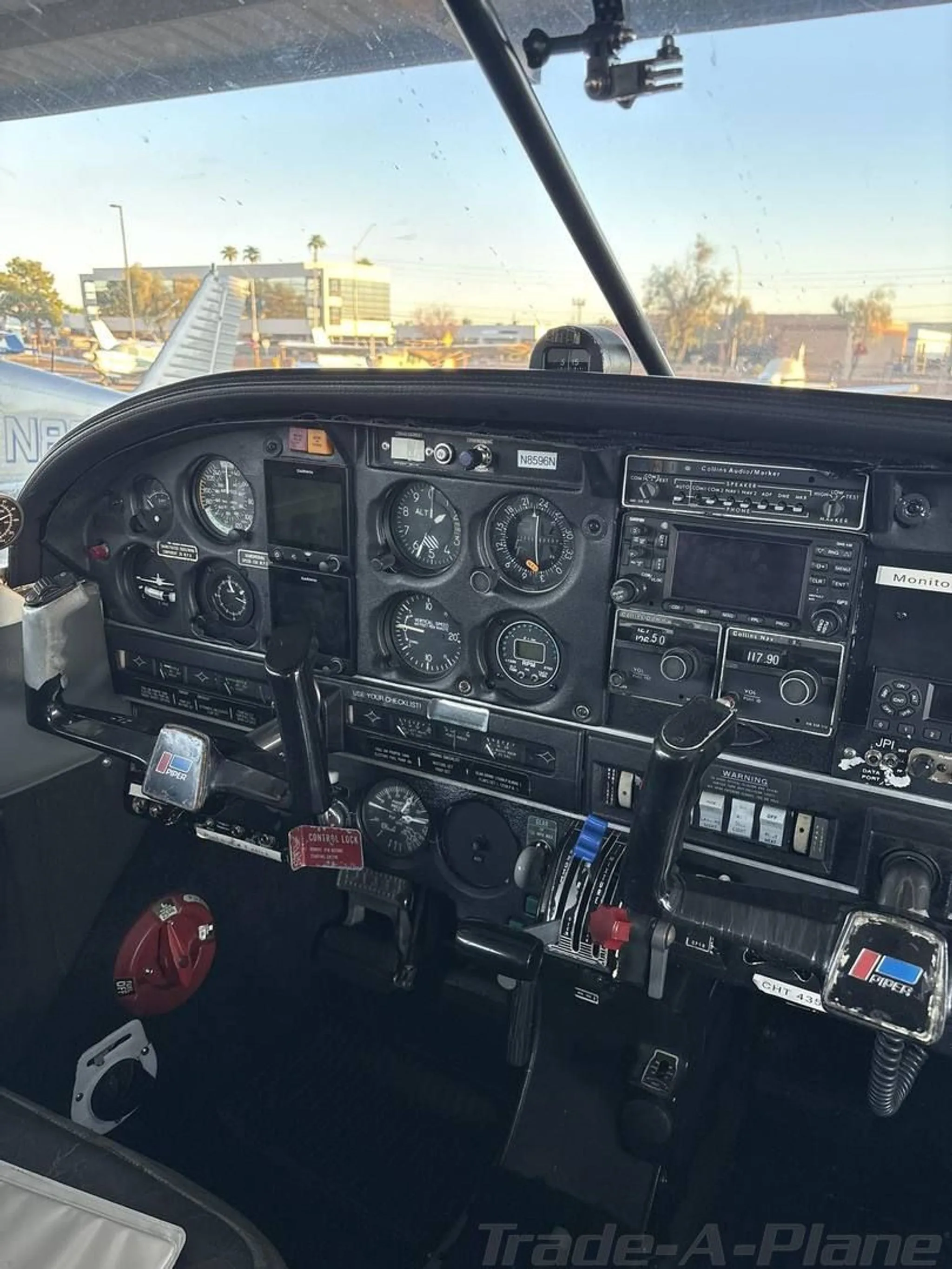 The cockpit instrument panel of a Piper aircraft, featuring analog gauges and avionics.