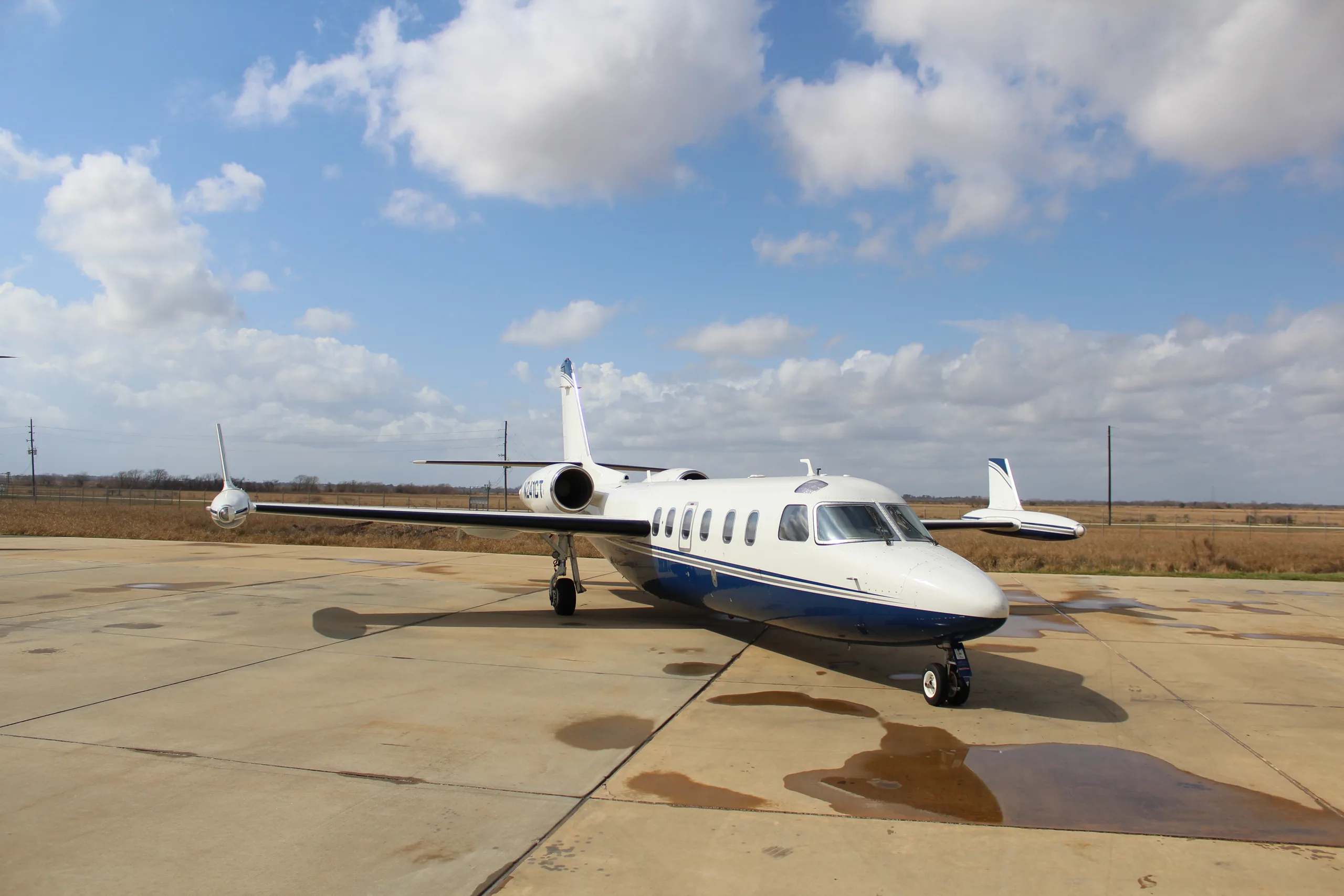 A Westwind Astra SPX aircraft with registration N241CT parked on the tarmac under a cloudy sky.