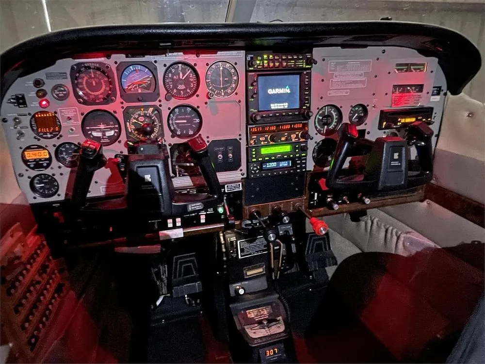 A close-up view of a Cessna P210 cockpit with various instruments and avionics.