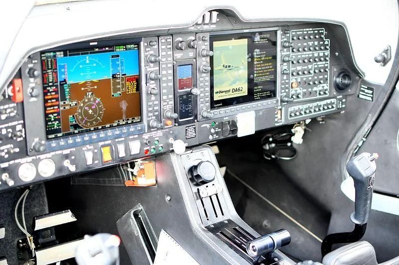 The modern glass cockpit of a Diamond DA62 aircraft, showing multiple display screens and controls.
