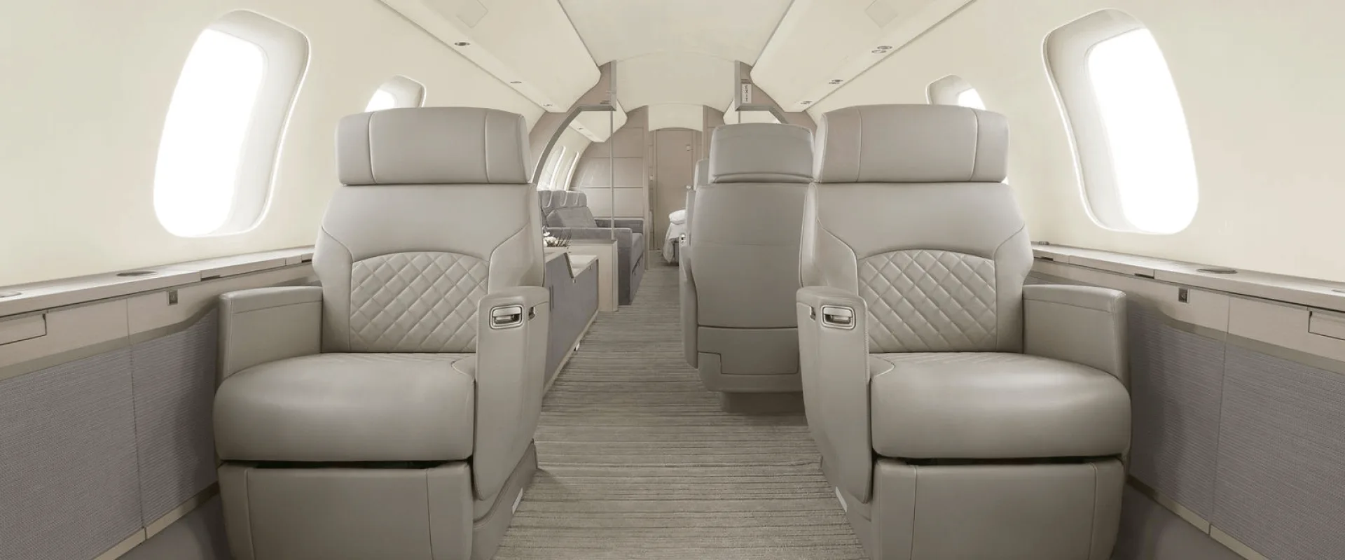 Aircraft cabin with leather seats and carpeted floor.