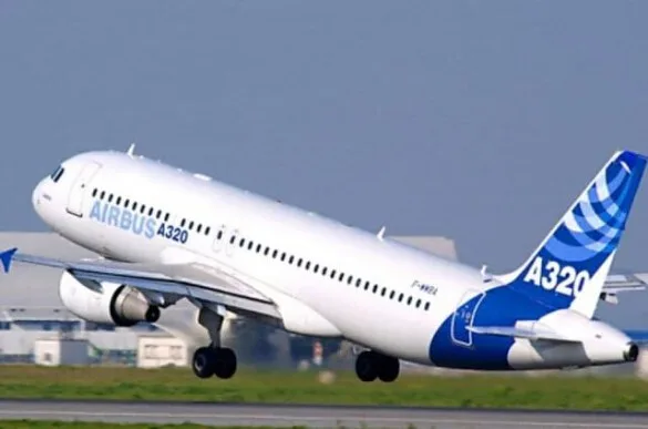 A white and blue Airbus A320 aircraft, with registration F-WWBA, is captured mid-takeoff from a runway.