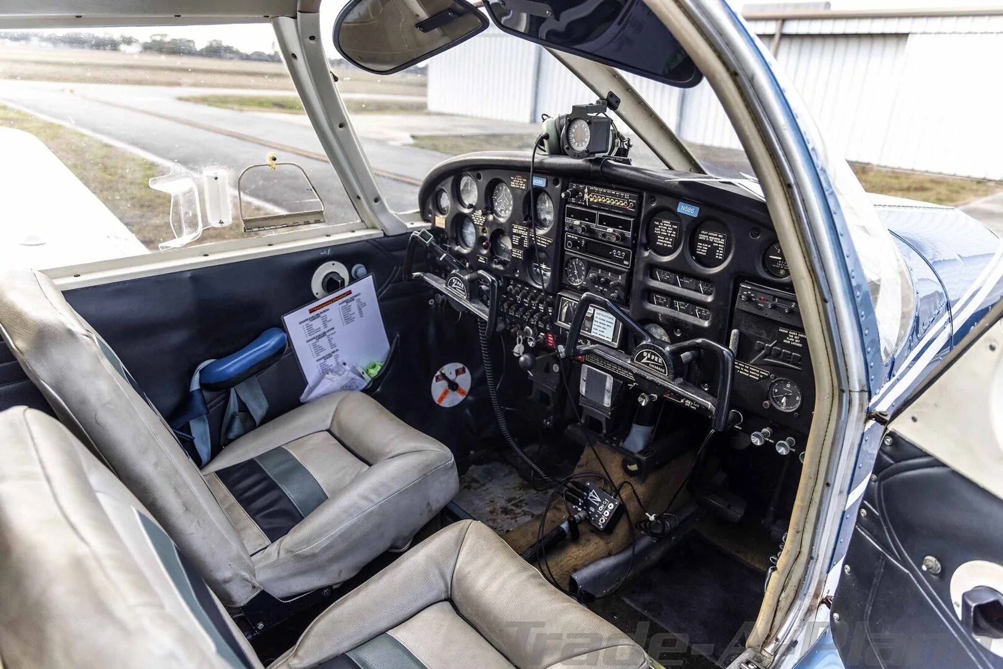 The cockpit of the Piper Cherokee N586, showing the instrument panel, controls, and front seats.