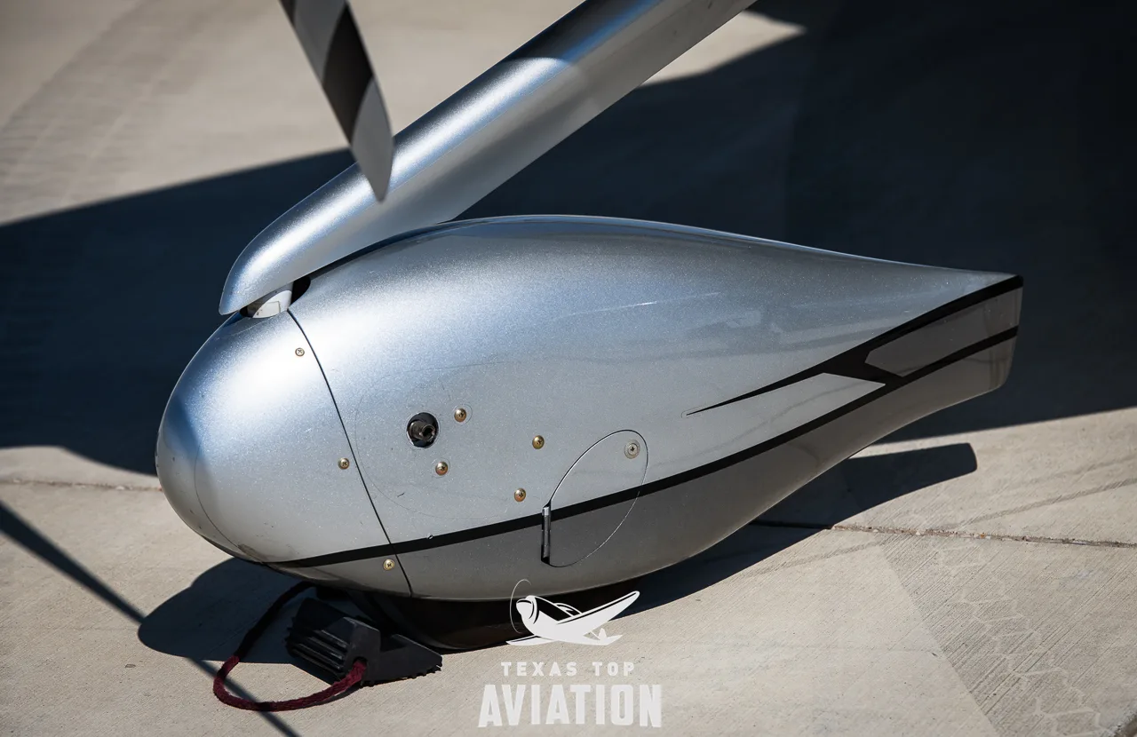 A close-up view of the silver landing gear fairing of the Cirrus SR22 aircraft.