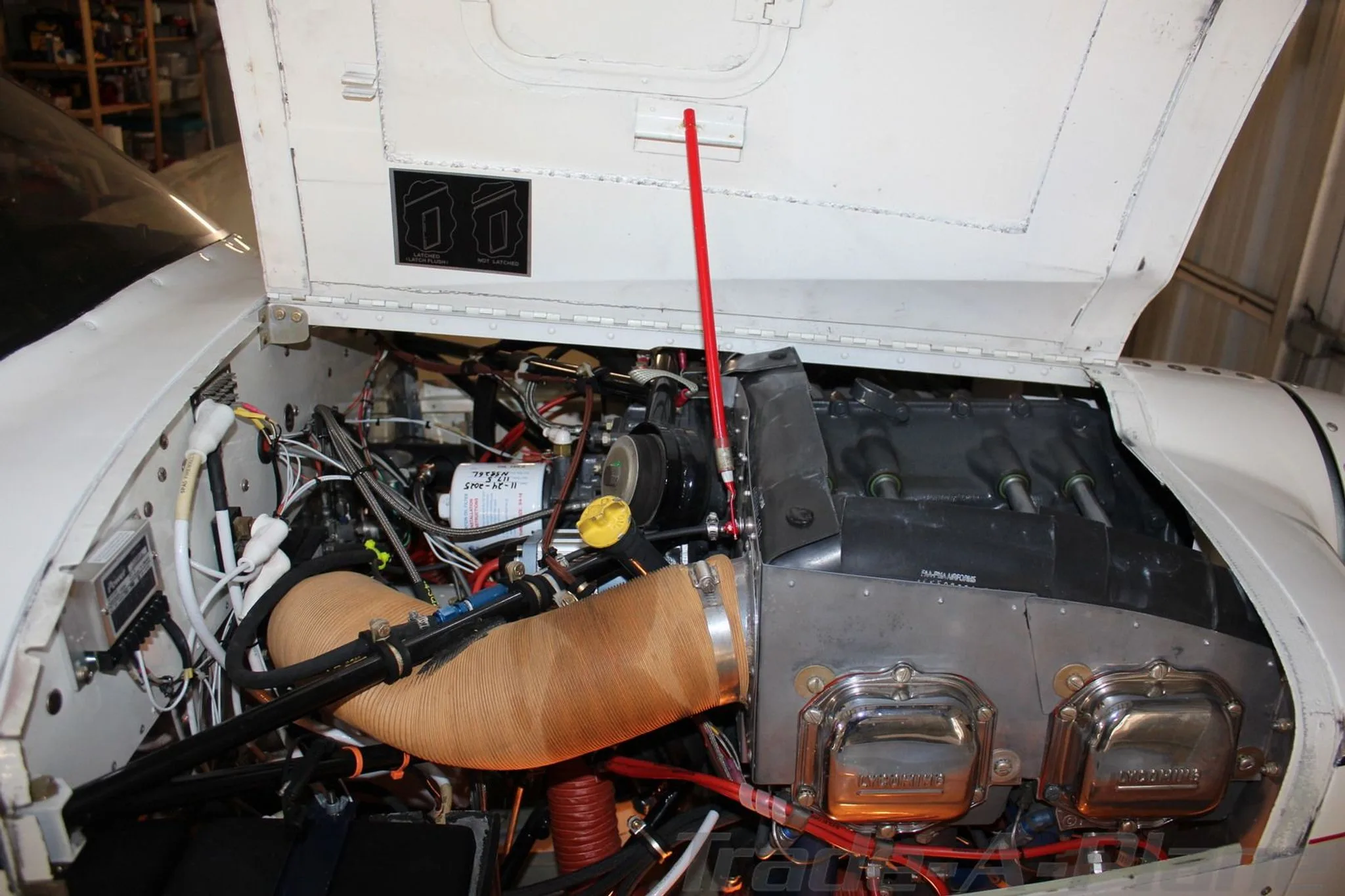 A detailed view of the N5826L aircraft's engine bay with the cowling open, showing the engine and various components.