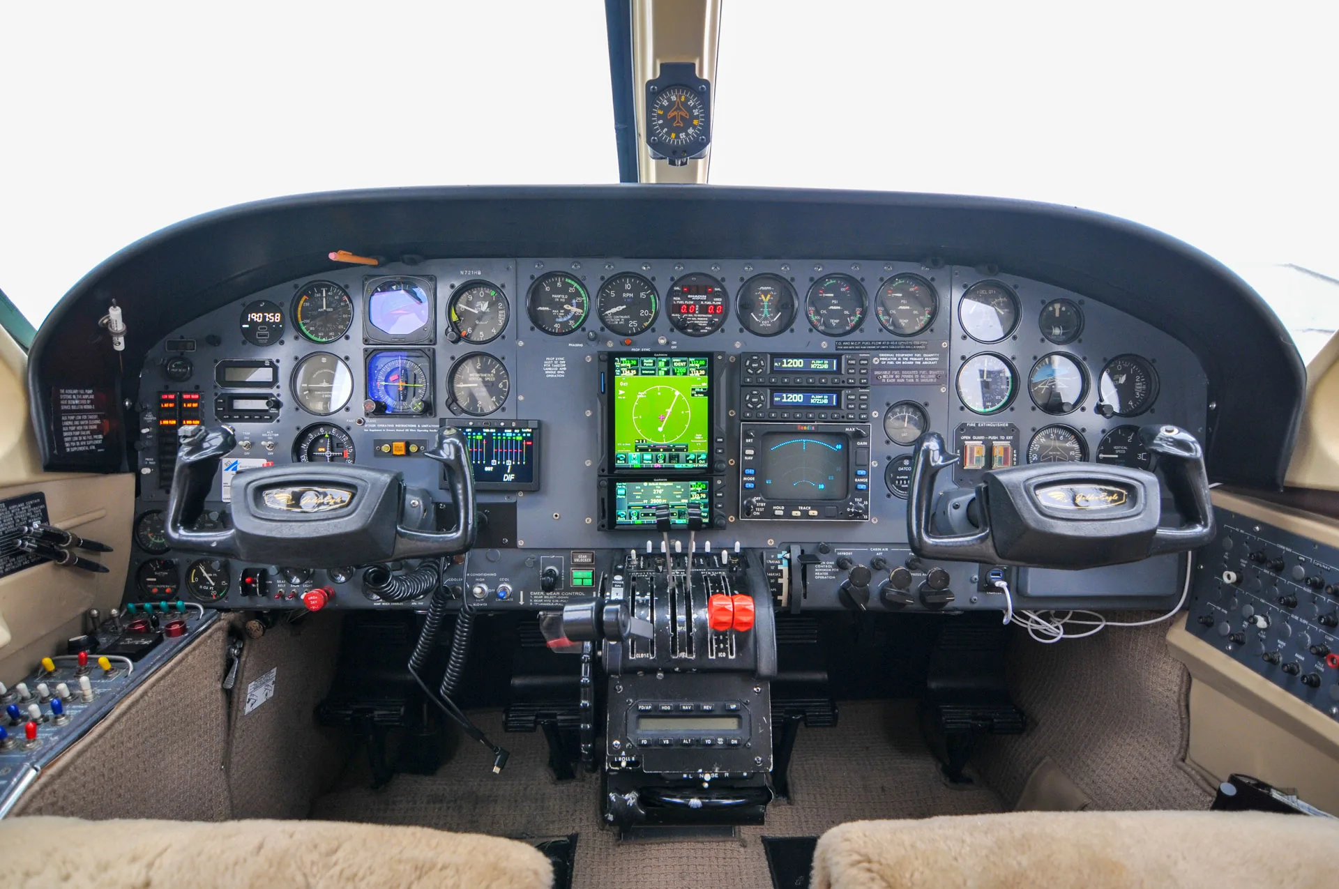 A detailed view of the aircraft's cockpit, featuring a mix of modern glass displays and traditional analog gauges.