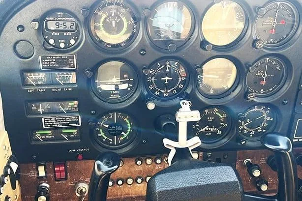 A close-up view of the instrument panel in a Cessna Cutlass RG II cockpit, showing gauges and controls.