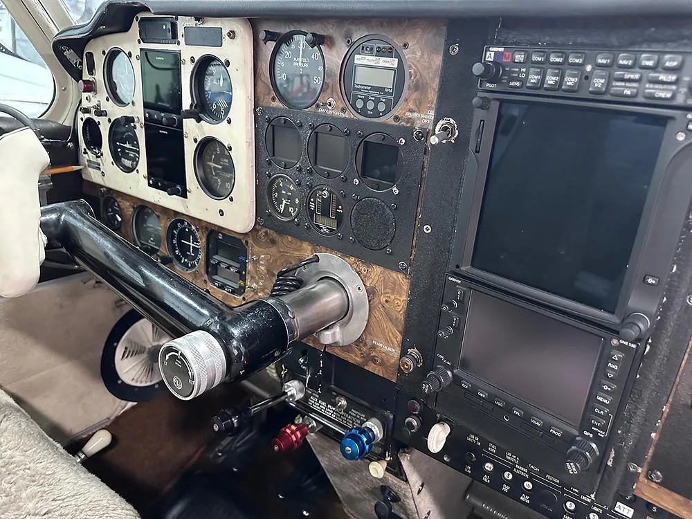 Close-up view of an aircraft cockpit with a detailed instrument panel and control yoke.