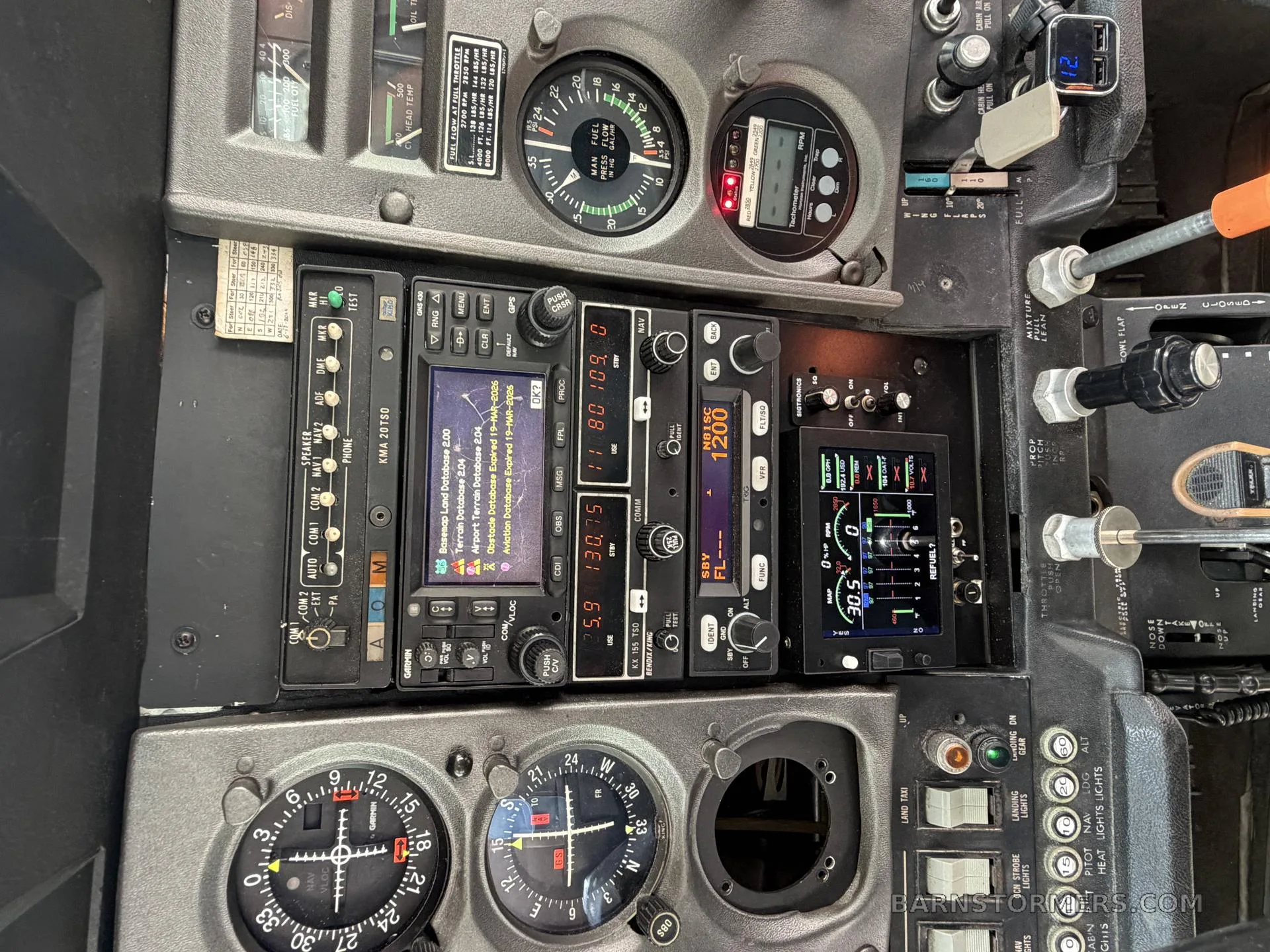 A detailed view of an aircraft's avionics stack, including radios, GPS, and other navigation instruments.