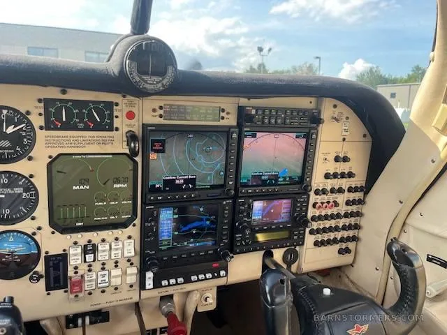 The cockpit instrument panel of a small aircraft, featuring multiple digital displays and analog gauges.
