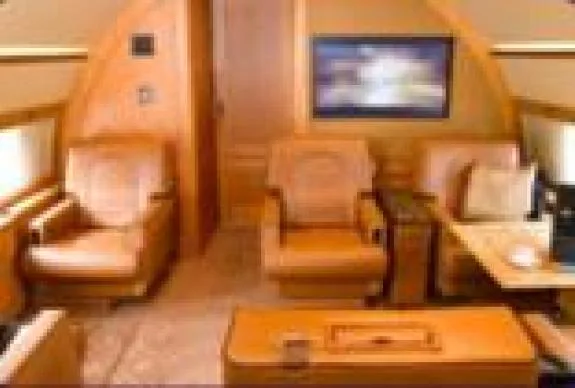 The interior of the aircraft features comfortable seating and a television.