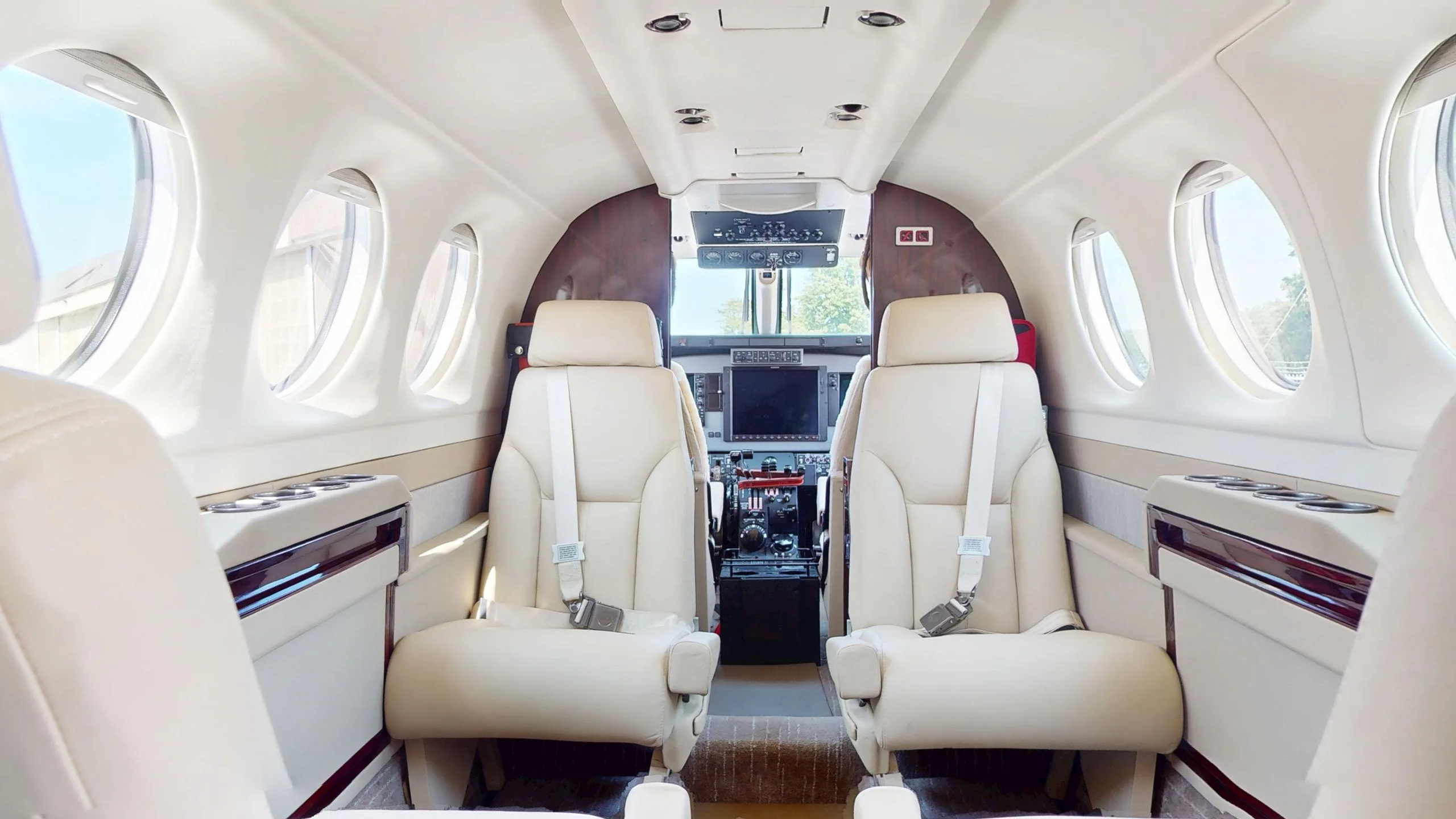 View of the King Air cabin showing leather seats and cockpit.