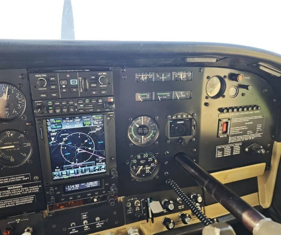 A close-up view of the right side of the aircraft's instrument panel, displaying navigation screens and engine controls.