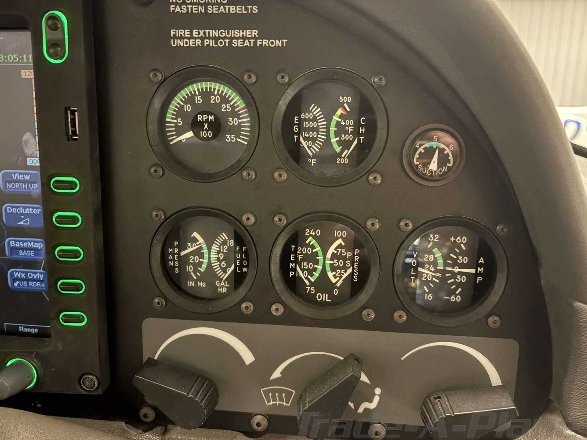 A close-up view of several analog gauges on the right side of a Cirrus SR20 cockpit panel.