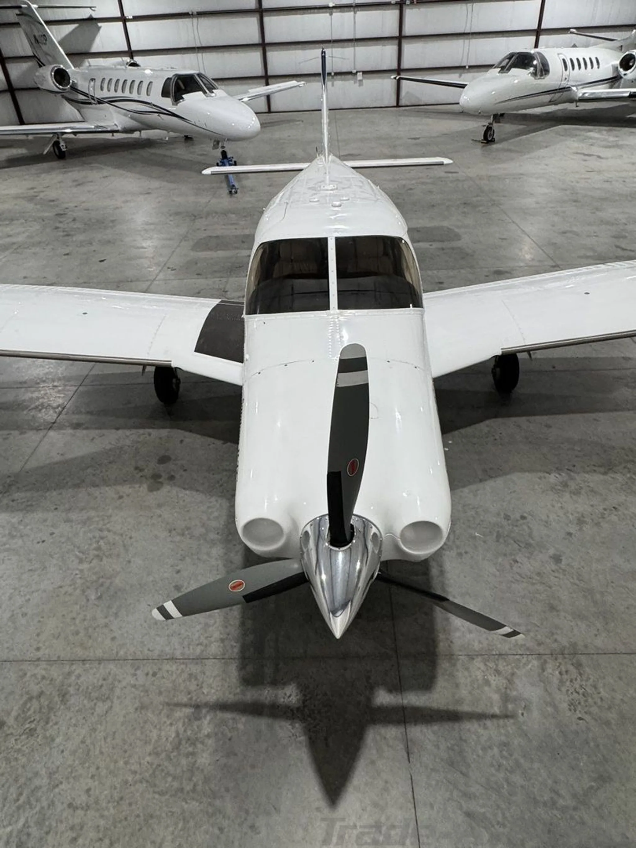 A close-up, slightly elevated front view of the propeller and nose of the Piper Saratoga II TC N436MA.