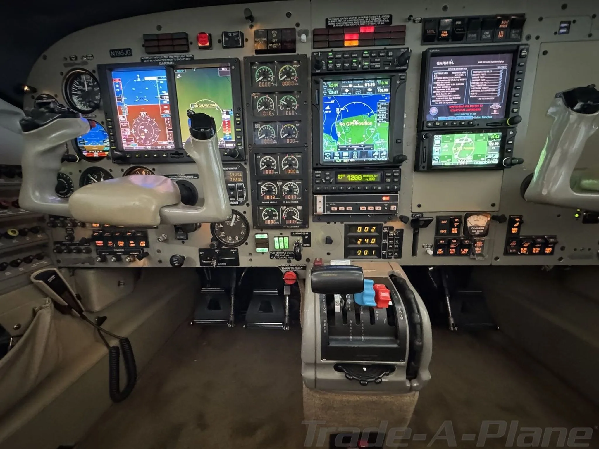 The cockpit of a Piper M-class aircraft, featuring multiple Garmin displays and flight controls.