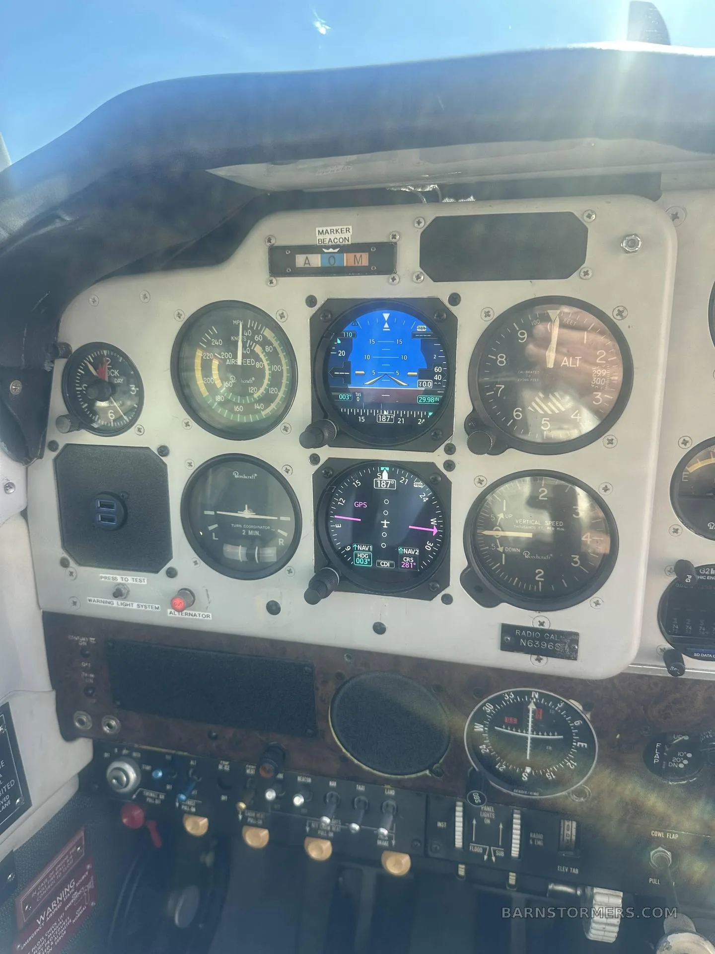 The instrument panel of a Beechcraft Debonair N6396S, featuring both analog gauges and modern digital displays.