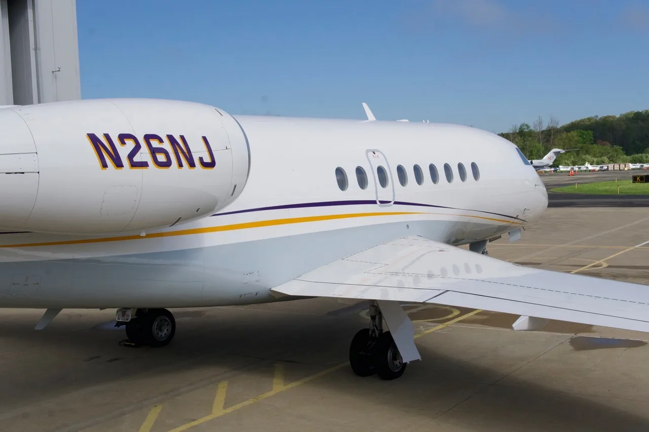 Close-up of the fuselage of the aircraft N26NJ showing the registration number.
