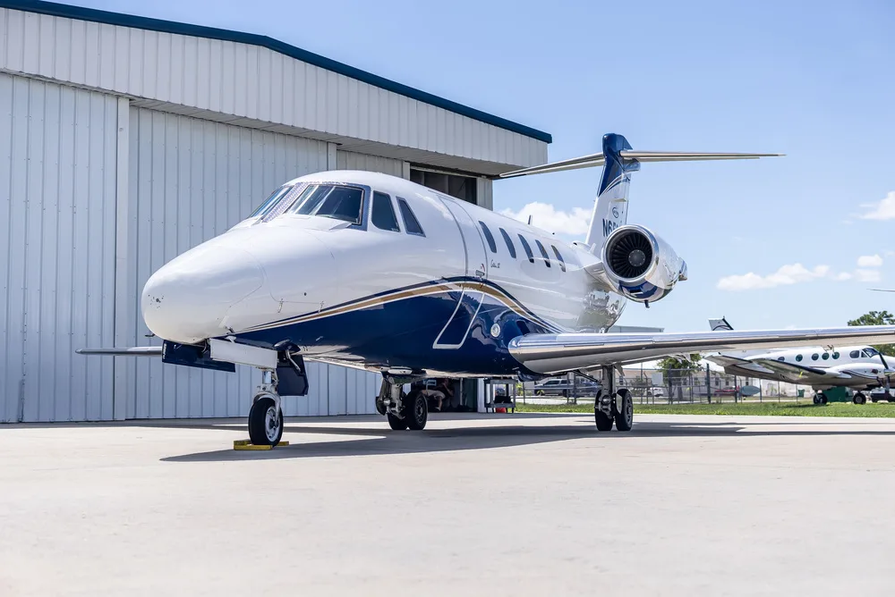 A front-right view of the white and blue Cessna Citation III business jet, N650AT, parked on an airfield.