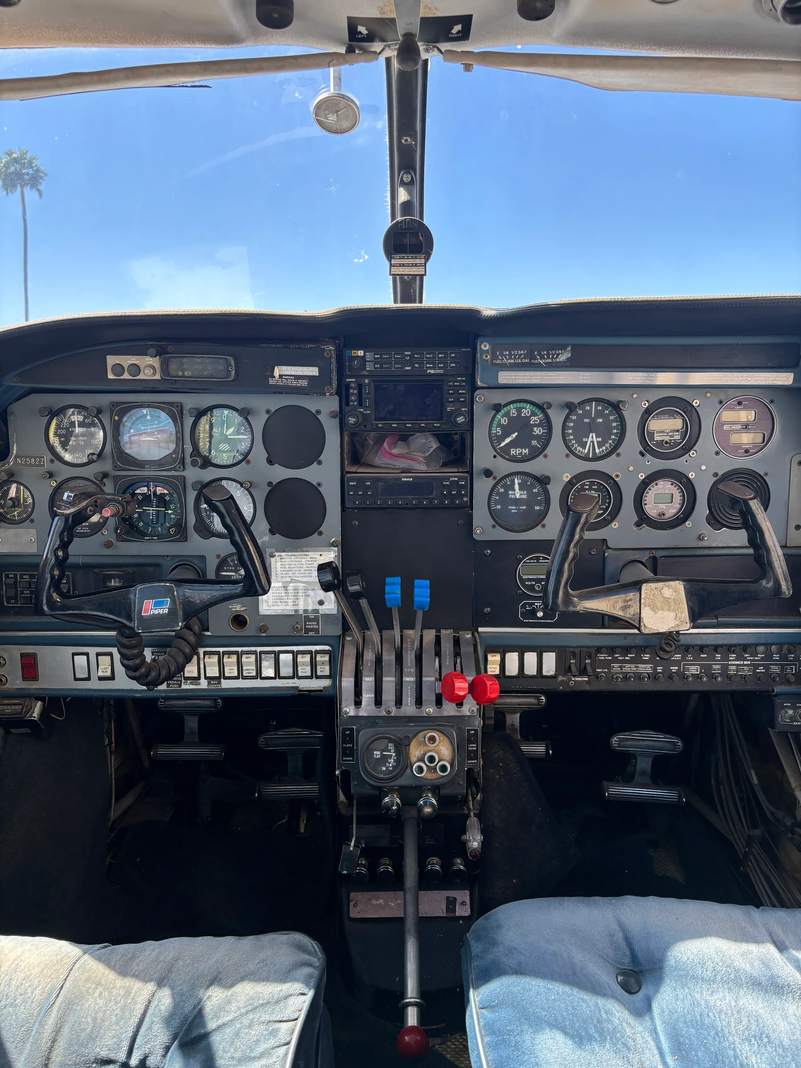 View of the aircraft cockpit with a dual yoke, instrument panel, and central throttle quadrant.