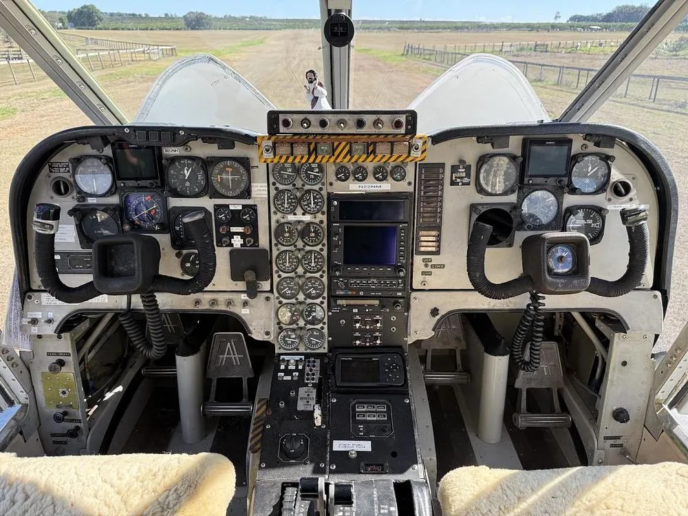 The cockpit instrument panel of an aircraft with a view of the runway through the windshield.
