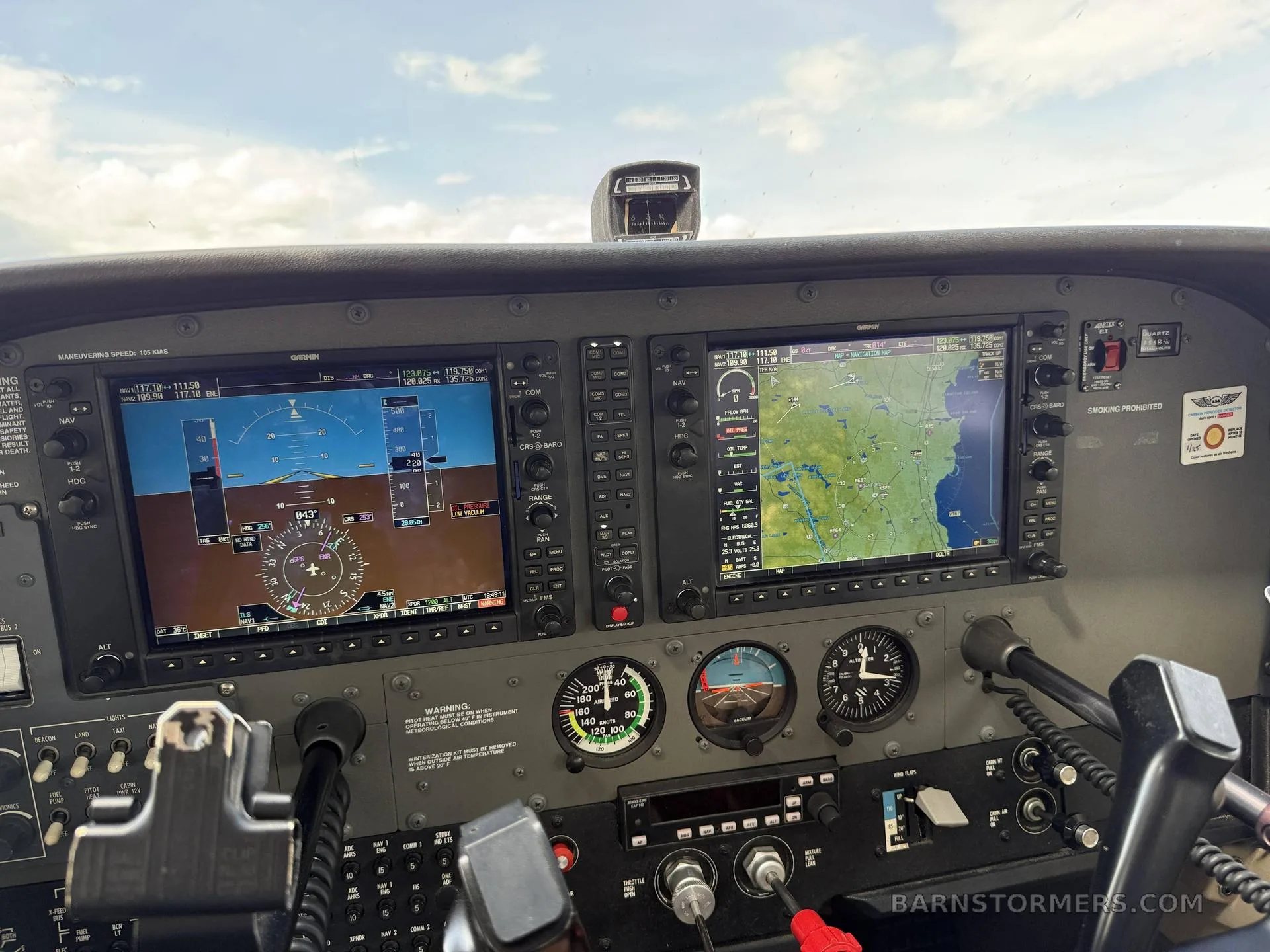 The cockpit of a Cessna 172 showing a modern glass panel with two large displays and traditional analog gauges.